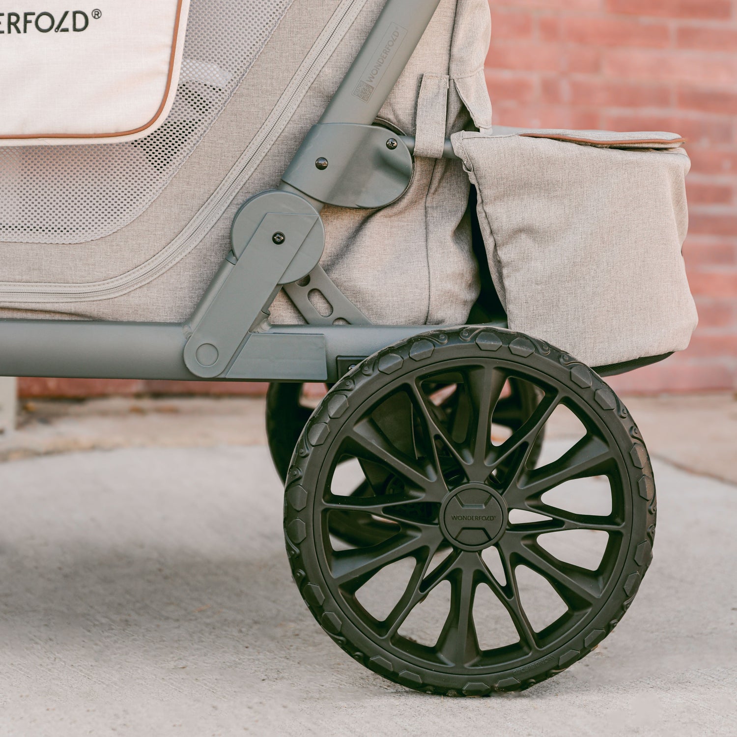 Close-up of the XL All-Terrain rear wheel of the WonderFold L2 stroller wagon made of Polyurethane, designed for a smooth ride.