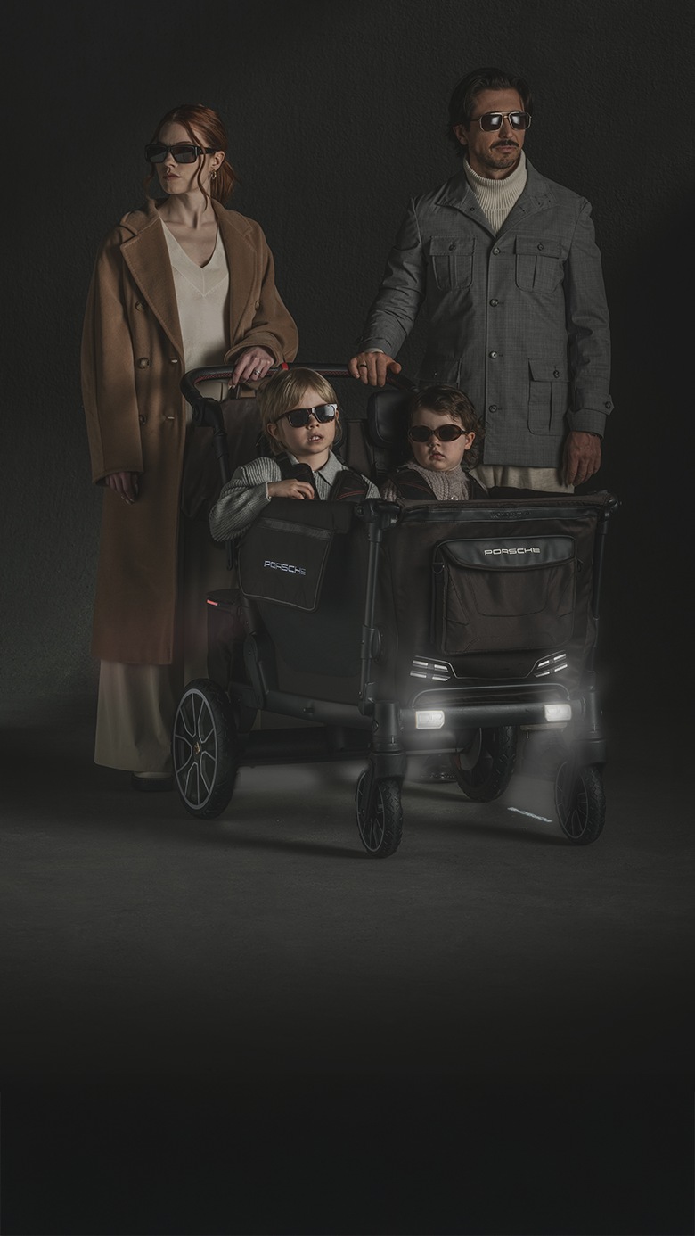 family with children in luxury stroller wagon wearing sunglasses
