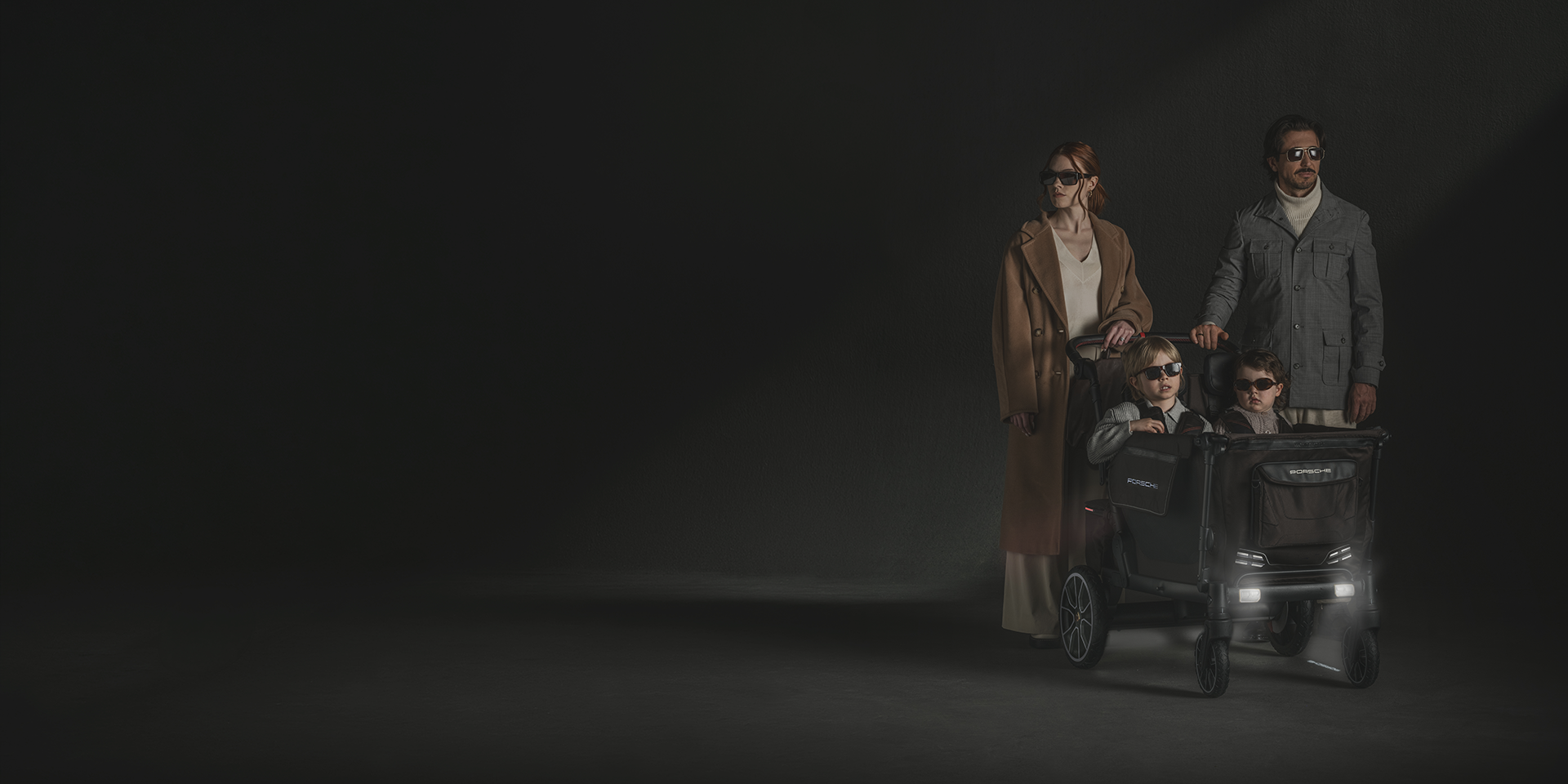 family with children in luxury stroller wagon wearing sunglasses