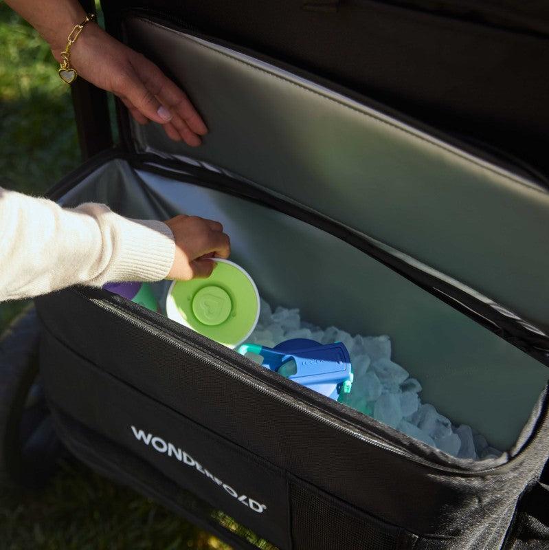 Parents puts items in W4 Luxe Pro's Insulated Rear Storage Basket with ample storage