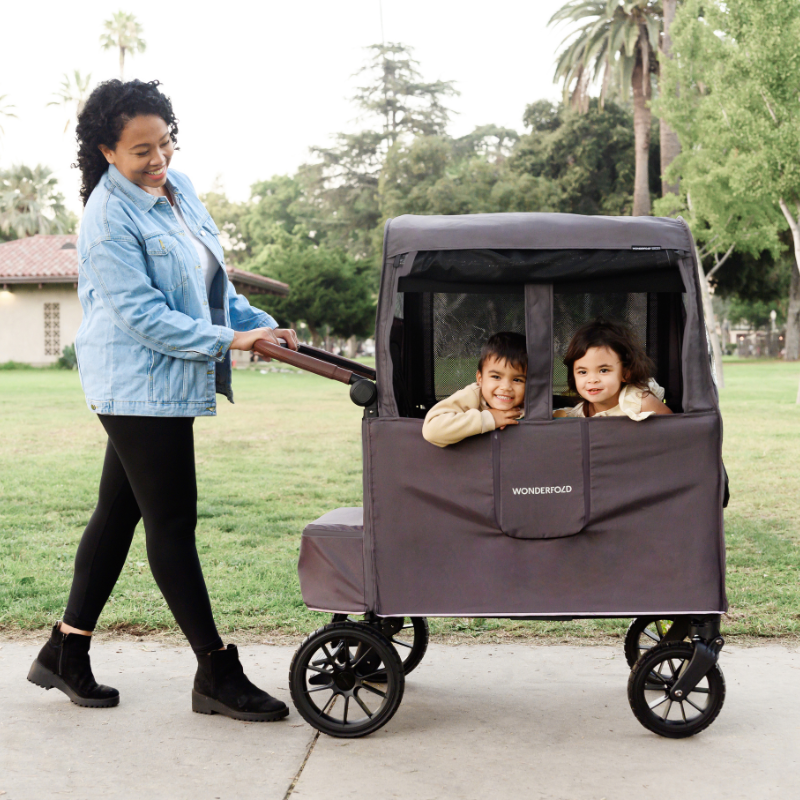 A walk during the cold with the stroller wagon equipped with weather cover