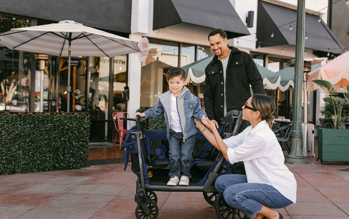 Toddler stepping into the L Series wagon through the side-entry door