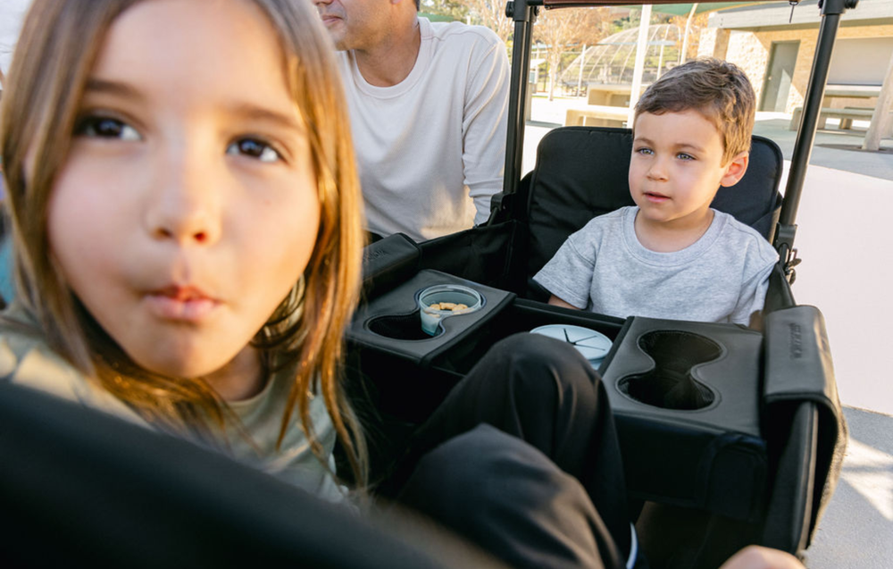 Two children sitting in the XR stroller wagon.