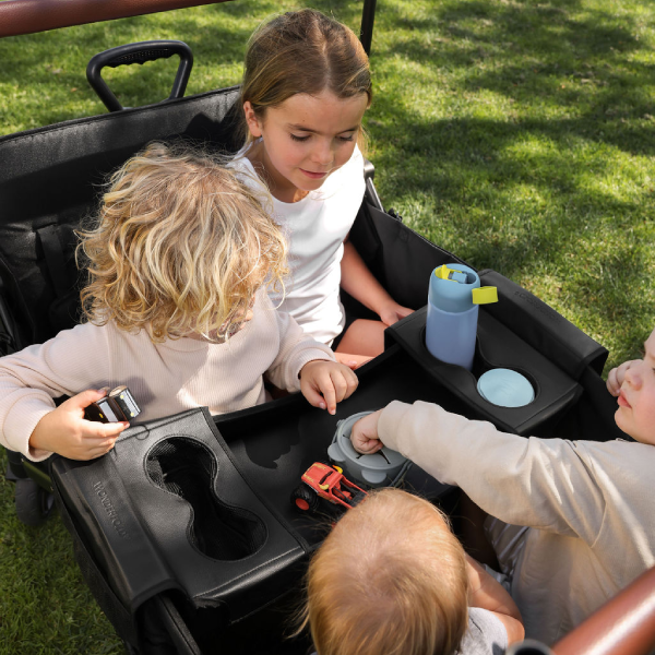 Four children sitting in the wonderfold xr stroller wagon.