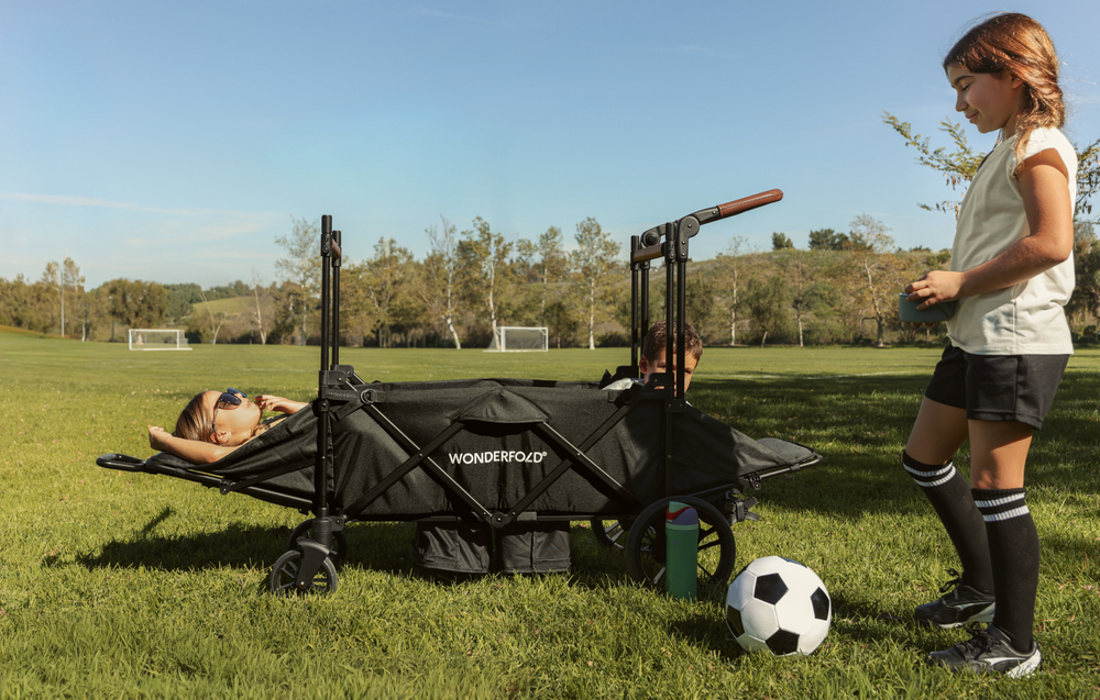 Children at soccer practice reclining in the XR stroller wagon.