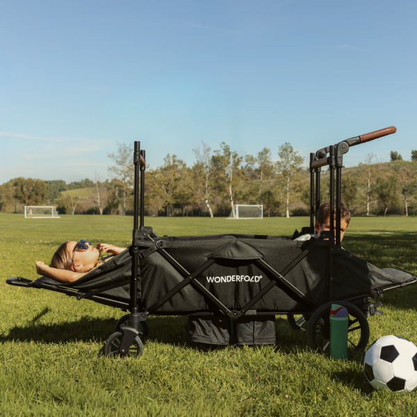 Children at soccer practice reclining in the XR stroller wagon.