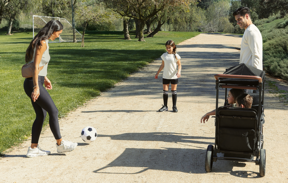 A family at soccer practice using the XR stroller wagon.