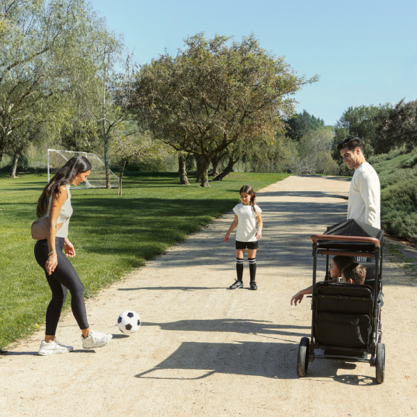 A family at soccer practice using the XR stroller wagon.